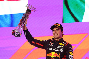 JEDDAH, SAUDI ARABIA - MARCH 19: Race winner Sergio Perez of Mexico and Oracle Red Bull Racing celebrates on the podium during the F1 Grand Prix of Saudi Arabia at Jeddah Corniche Circuit on March 19, 2023 in Jeddah, Saudi Arabia. (Photo by Lars Baron/Getty Images)