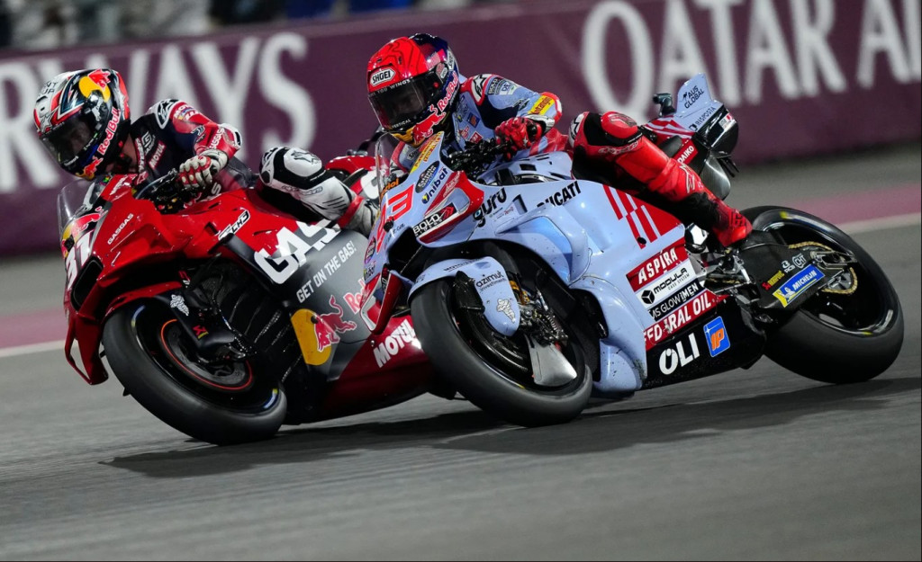 Pedro Acosta and Marc Marquez battle at the Qatar GP. Acosta is forcing his bike up the inside of Marquez. 